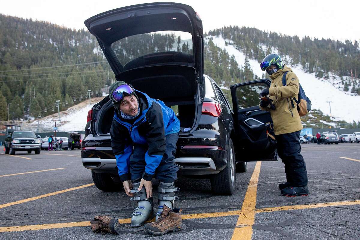 Mike Ernst (left) and Justin Suveg of New Jersey gear up to ski and snowboard at Heavenly Mountain Resort in South Lake Tahoe, December 10, 2020.