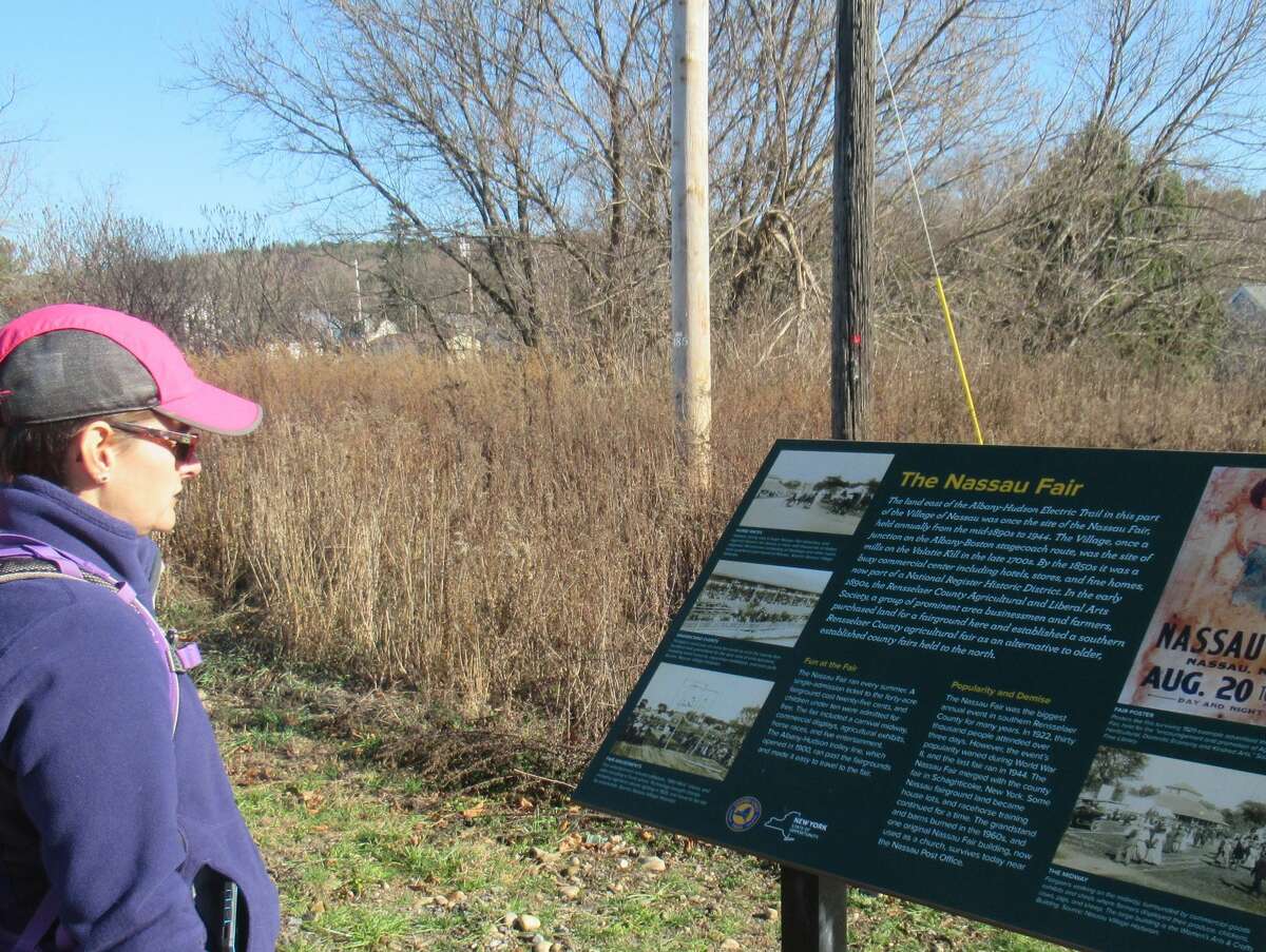 Gillian Scott looks over an informational sign along the new Albany-Hudson Electric Trail. (Herb Terns / Times Union)
