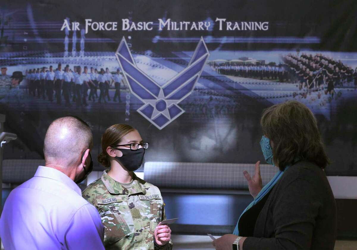 Amy Biggers (center) chats with officials after she and six other trainees, the first assigned to the U.S. Space Force, graduate from Air Force basic training Thursday at Joint Base San Antonio-Lackland with 407 other recruits. For the next several months, the seven Space Force enlistees will continue with their training specific to Space Force.