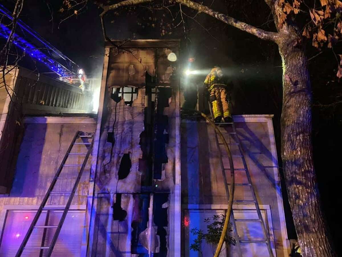 The Woodlands Fire Department firefighters are seen in December 2020 after ending a chimney blaze at a home in Grogan's Mill Village. The Montgomery County Fire Marshal’s Office is warning residents about these next three months being “peak” season for home heating fires.