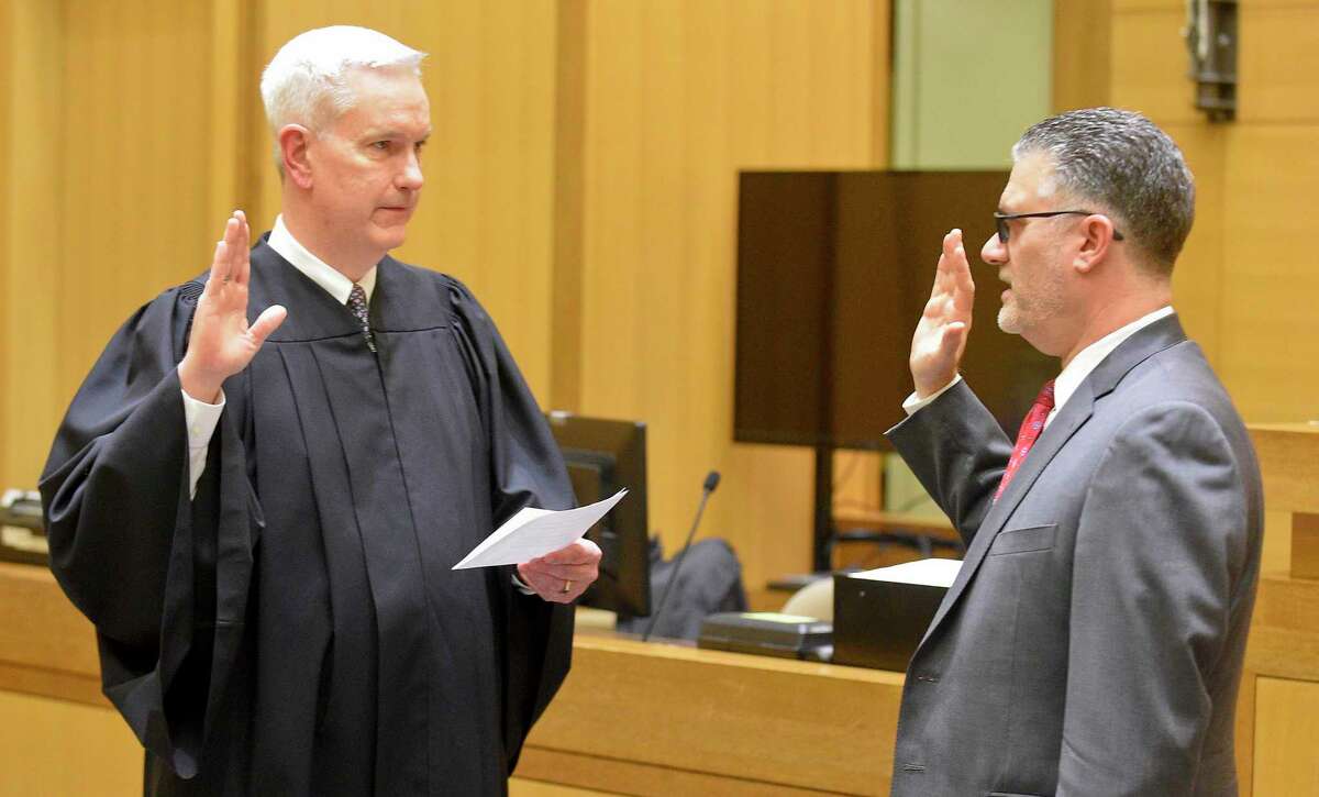 Supreme Court Associate Justice Andrew J. McDonald, left, administered the oath of office last year to Richard Colangelo Jr., the chief state's attorney.