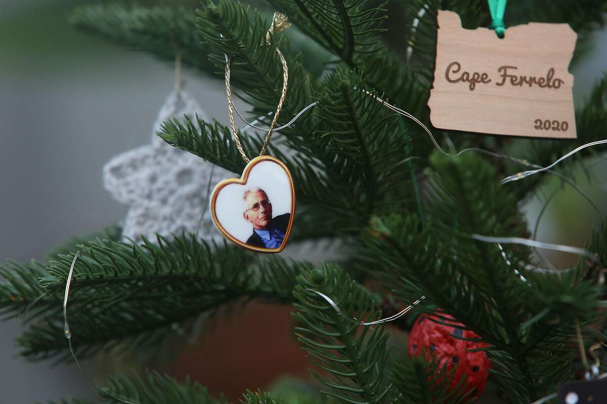 A doctor Fauci ornament (left), to honor his role during the pandemic, and an Oregon ornament (right), where Graves and Wise were recently engaged, and a childhood ornament of Graves made out of a walnut (bottom red) hang on Graves and Wise’s Christmas tree on Friday, December 11, 2020 in San Francisco, Calif. This Christmas will be the first of 47 that Graves will not be in Massachusetts with his family.