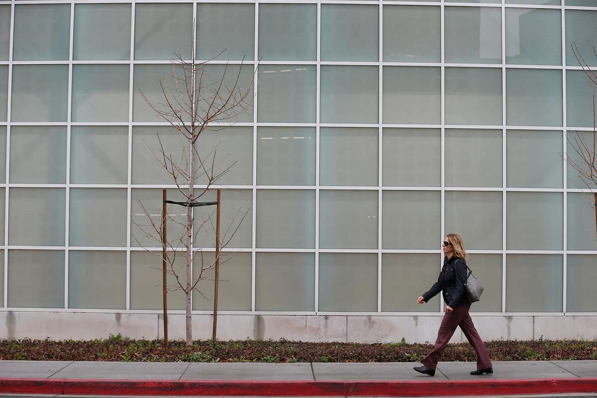 A woman walks through the Oracle campus in Redwood City in 2018.