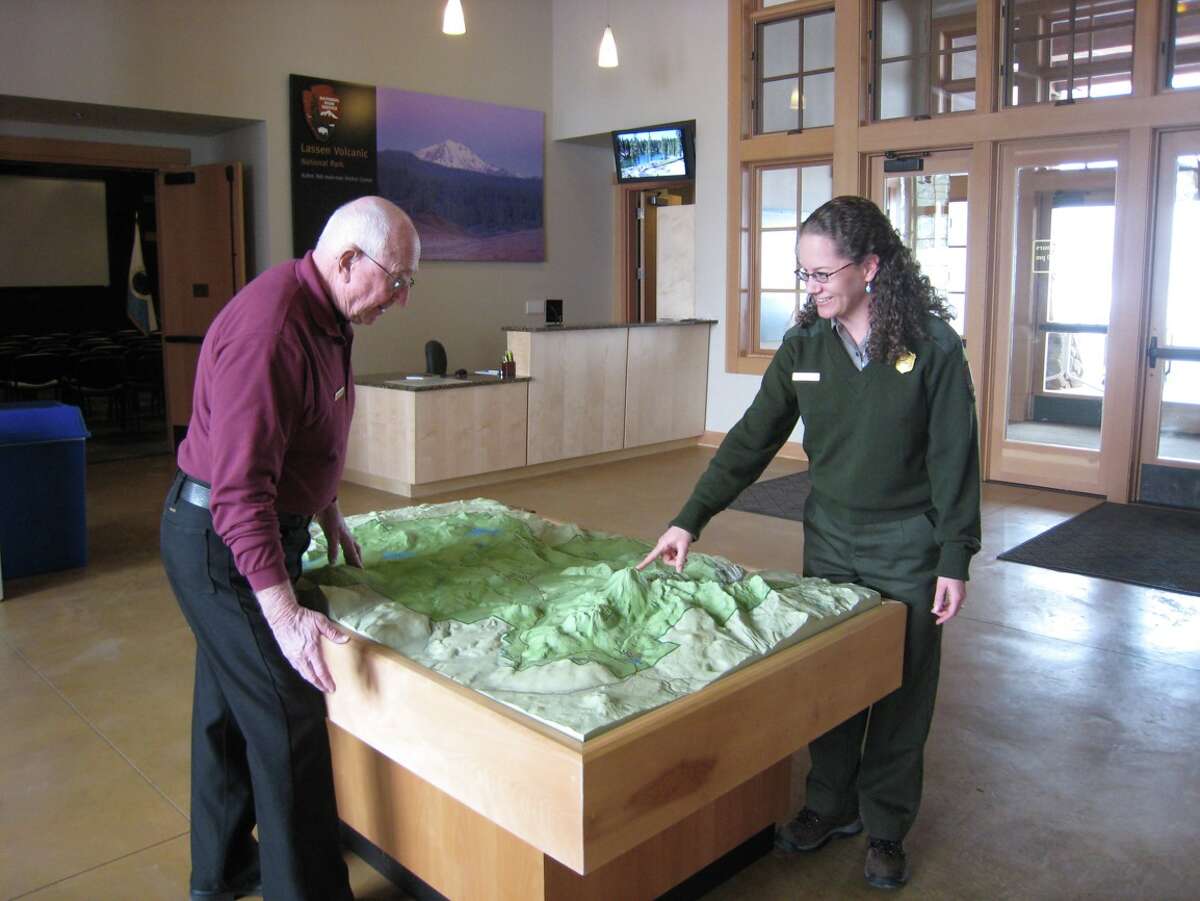Park ranger Shanda Ochs and a visitor at Kohm Yah-mah-nee Visitor Center in Lassen Volcanic National Park.