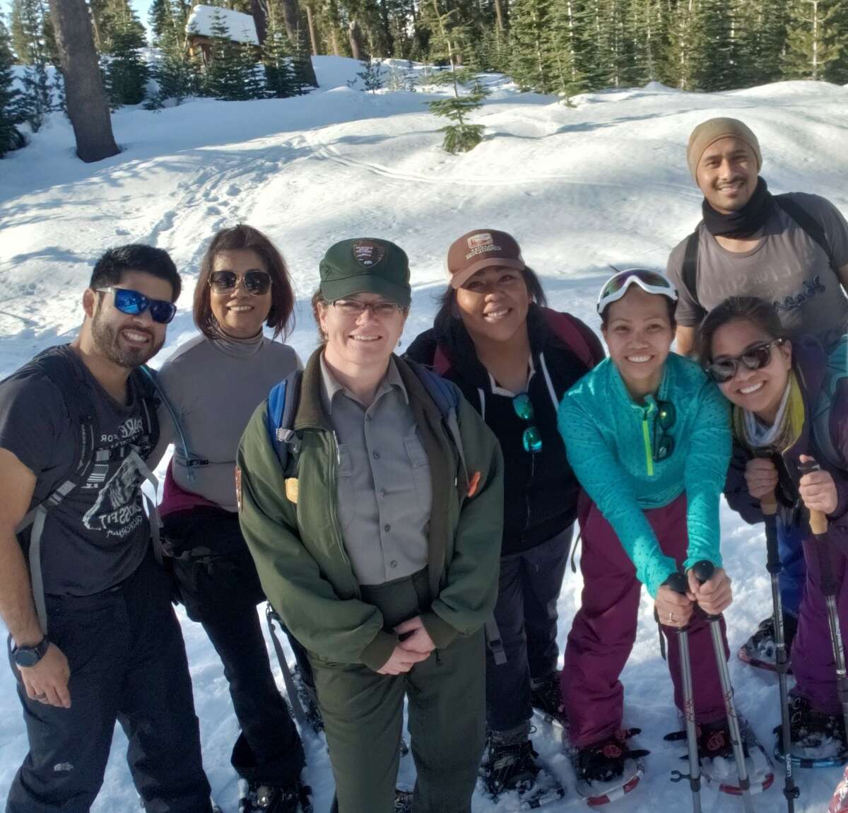 Park ranger Shanda Ochs and group of snowshoe walk participants outside of the Kohm yah-mah-nee Visitor Center.