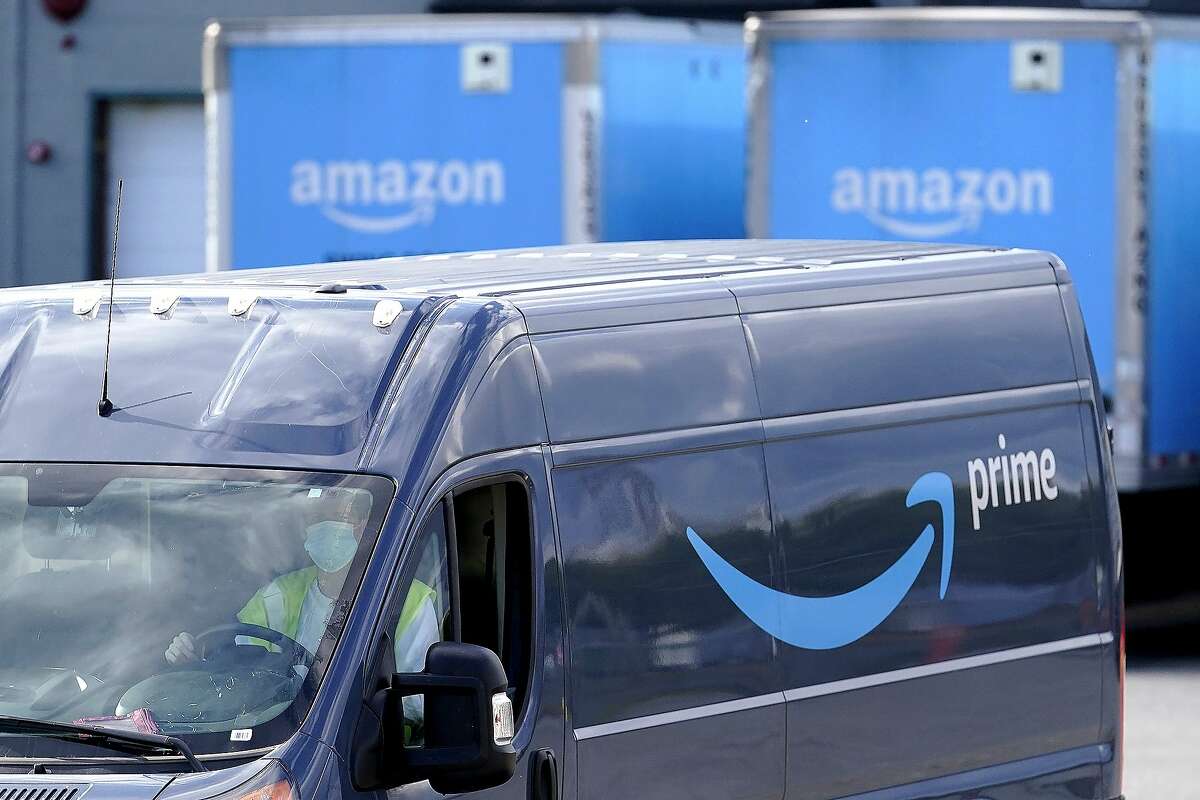In this Oct. 1, 2020 file photo, an Amazon Prime logo appears on the side of a delivery van as it departs an Amazon Warehouse.