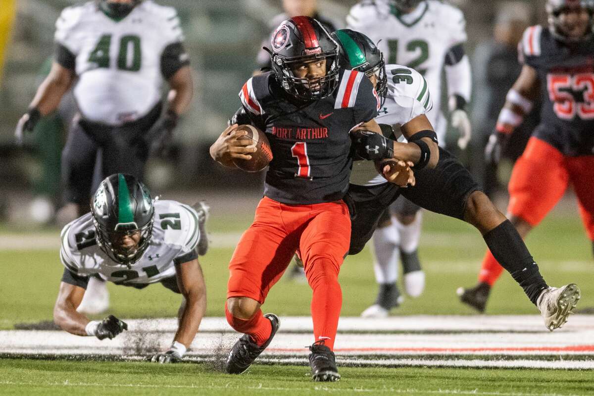 Titans Jah'mar Sanders (1) evades a tackler as he carries the ball in the second quarter. The Port Arthur Titans battled with the Fort Bend-Hightower Hurricanes in bi-district football playoff action Friday night. Photo made on December 11, 2020. Fran Ruchalski/The Enterprise