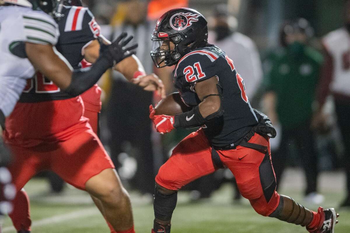 Titans Branden Chaney (21) carries the ball in the second quarter. The Port Arthur Titans battled with the Fort Bend-Hightower Hurricanes in bi-district football playoff action Friday night. Photo made on December 11, 2020. Fran Ruchalski/The Enterprise