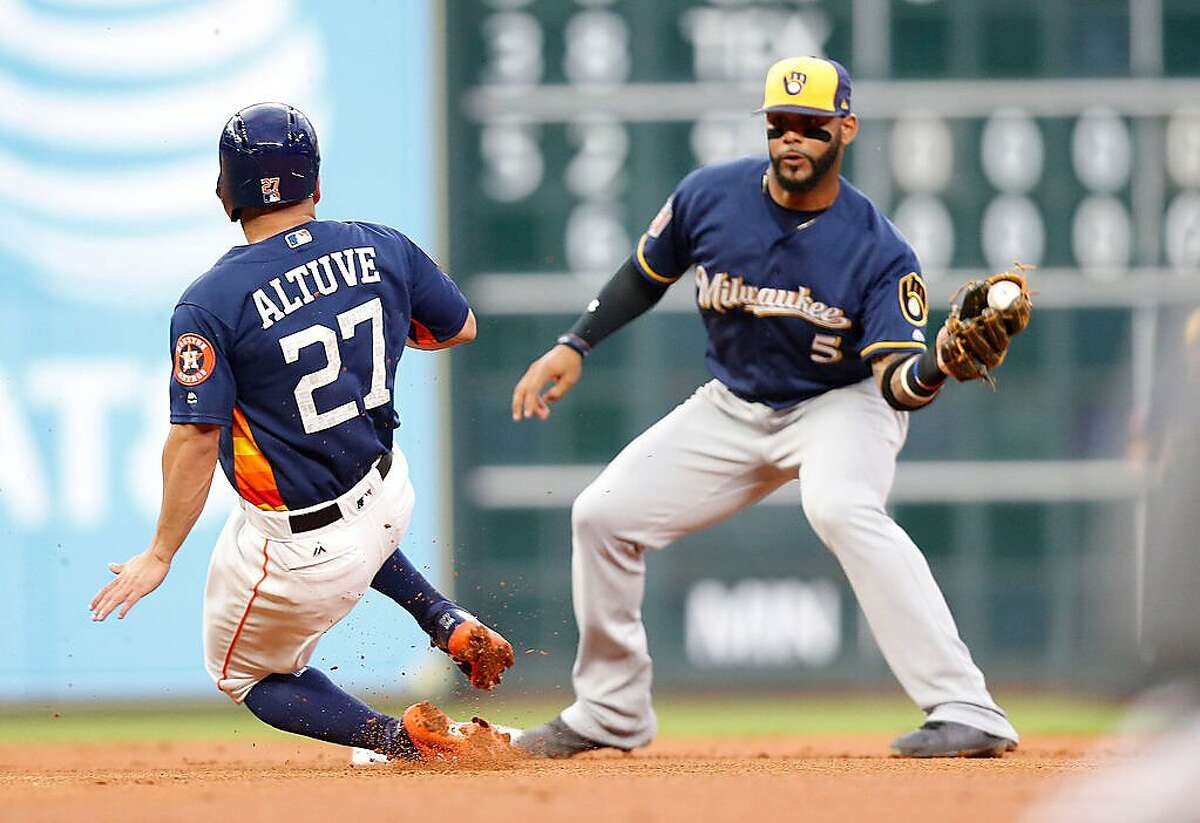Houston Astros second baseman Jose Altuve (27) is out at first uner second baseman Jonathan Villar (5) in the first inning at Minute Maid Park on Monday, March 26, 2018, in Houston. ( Elizabeth Conley / Houston Chronicle )