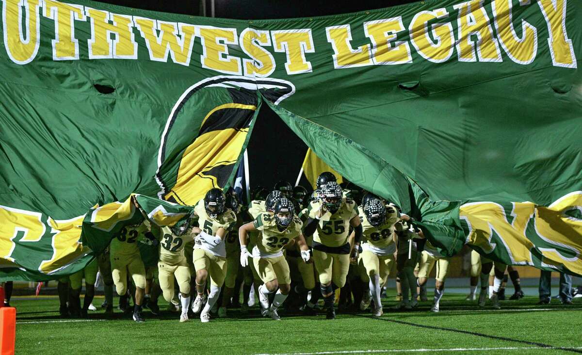 The Southwest Legacy Titans enter the field for their playoffs game against Highlands at Titan Stadium on Friday, Dec. 11, 2020.
