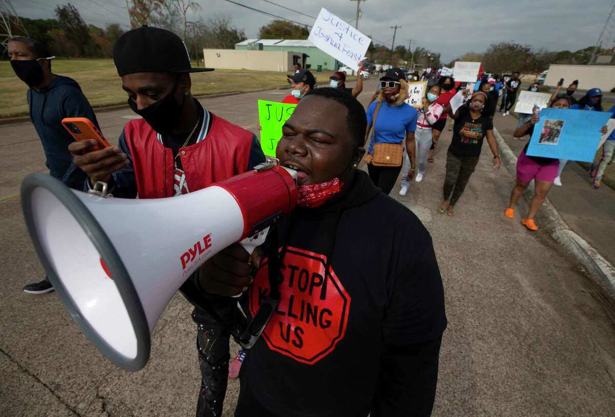 Jarrod Holt leads a chant during a march in La Marque, Texas on Saturday, Dec. 12, 2020, to protest the shooting of Joshua Feast, 22, by a La Marque police officer. Officials say Officer Jose Santos fatally shot Feast late Wednesday. (Stuart Villanueva /The Galveston County Daily News via AP)