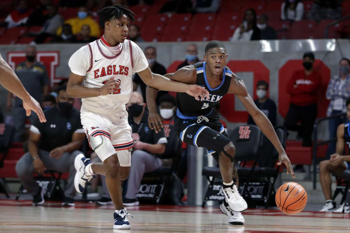 Shadow Creek's Shawn Jones (5) brings the ball down court under pressure from Atascocita's Cameron Morrison, left, during their Holiday Hoopfest game at the Fertitta Center Saturday, Dec. 12, 2020 in Houston, TX.