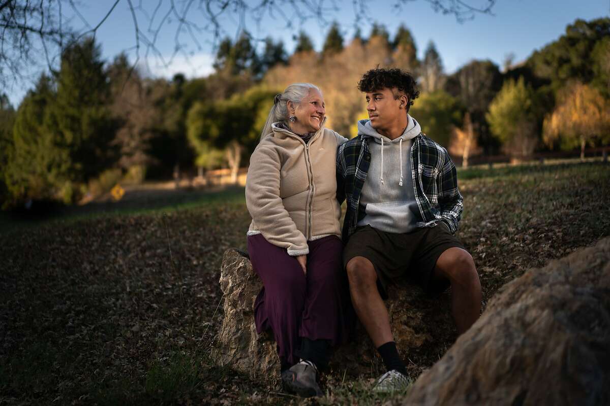 Deirdre McDonald chats with son Sage Urbaez, 17, across the street from their home in San Geronimo. Season of Sharing helped the family with rent.