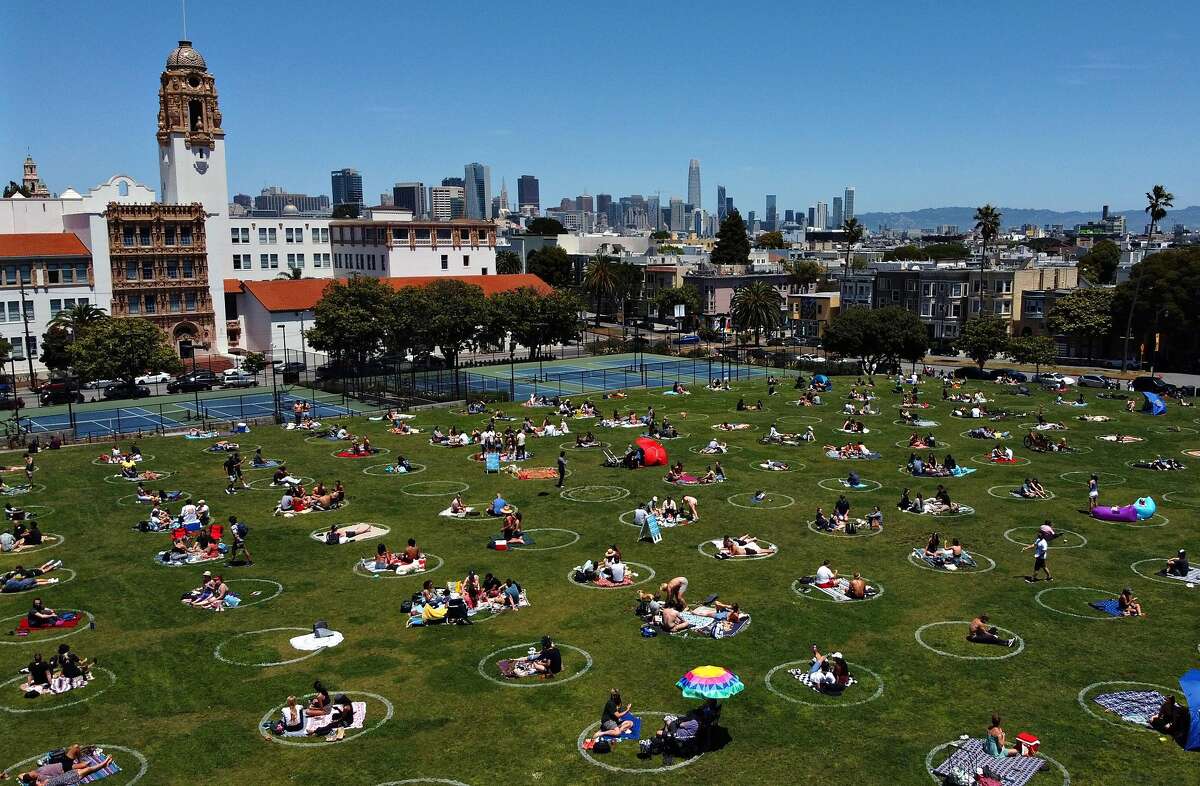 Visitors use Dolores Park’s social distancing circles in May. Dating is tricky under the new shutdown order — but possible as long as it’s outdoors and platonic.