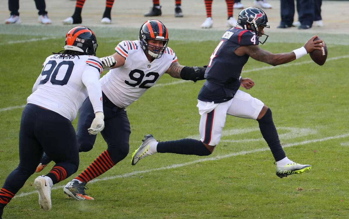 Houston Texans quarterback Deshaun Watson (4) is forced out of the pocket by Chicago Bears defensive tackle John Jenkins (90) and defensive end Brent Urban (92) during the second half of an NFL football game at Soldier Field Sunday, Dec. 13, 2020, in Chicago.