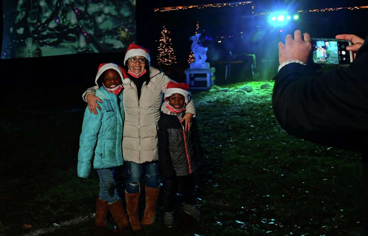 The Carrena family takes a photo as Celebrate Shelton holds its seventh annual community tree lighting Friday, December 11, 2020, at the Rotary Pavilion at Veteran’s Memorial Park in Shelton, Conn. In addition to the tree lighting and the visit from Santa and Mrs. Claus, the event featured an ice sculpture demonstration by Ice Matters; a fire dance performance with Sarotonin Performance Arts; and a holiday dance party. The community tree lighting was sponsored by the city, Center Stage Theatre, Apple Rehab, Jones Family Farm, Echo Hose Hook & Ladder Co. 1 and Valley Community Foundation.