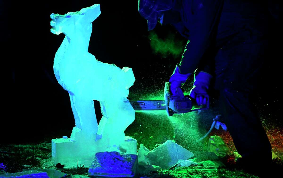 Bill Cobitz performs a ice sculpture demonstration by Ice Matters as Celebrate Shelton holds its seventh annual community tree lighting Friday, December 11, 2020, at the Rotary Pavilion at Veteran's Memorial Park in Shelton, Conn. In addition to the tree lighting and the visit from Santa and Mrs. Claus, the event featured an ice sculpture demonstration by Ice Matters; a fire dance performance with Sarotonin Performance Arts; and a holiday dance party. The community tree lighting was sponsored by the city, Center Stage Theatre, Apple Rehab, Jones Family Farm, Echo Hose Hook & Ladder Co. 1 and Valley Community Foundation.