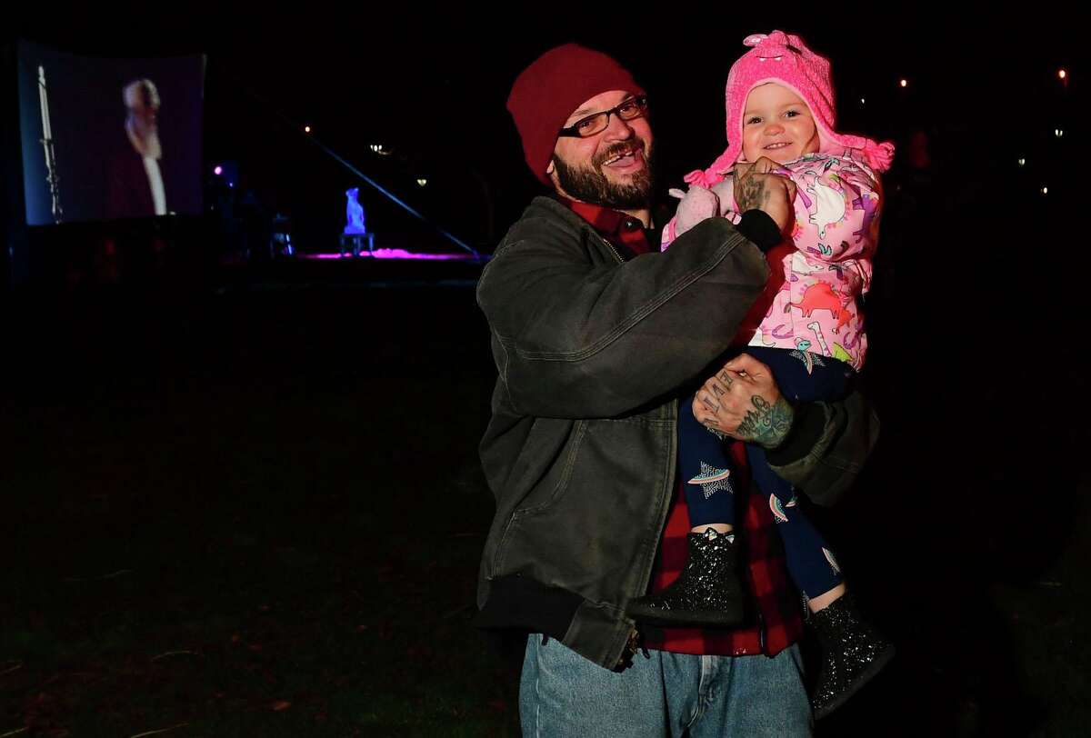 Michael and Raelynn Atkins visit as Celebrate Shelton holds its seventh annual community tree lighting Friday, December 11, 2020, at the Rotary Pavilion at Veteran's Memorial Park in Shelton, Conn. In addition to the tree lighting and the visit from Santa and Mrs. Claus, the event featured an ice sculpture demonstration by Ice Matters; a fire dance performance with Sarotonin Performance Arts; and a holiday dance party. The community tree lighting was sponsored by the city, Center Stage Theatre, Apple Rehab, Jones Family Farm, Echo Hose Hook & Ladder Co. 1 and Valley Community Foundation.