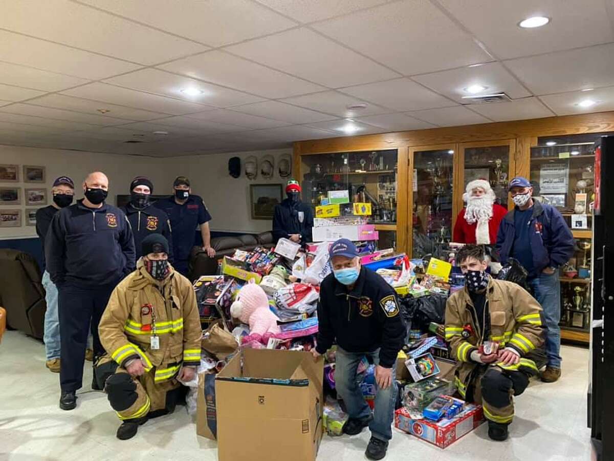 Santa Claus, alongside his firefighting elves, collected dozens of donated toys rode during his ride through the White Hills of Shelton on Saturday.