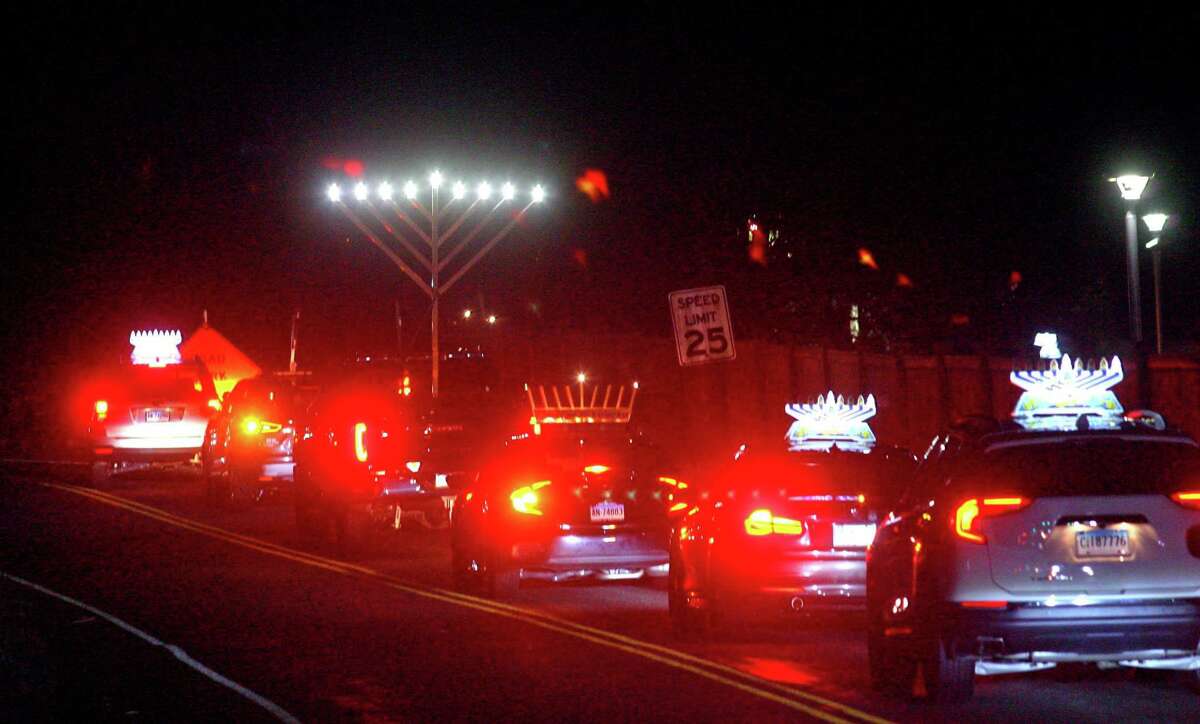 Up to 40 vehicles take part in a Car Menorah Parade and arrive at Chabad of Westport in Westport, Conn., on Thursday Dec. 10, 2020. A Menorah lighting to celebrate Hanukkah and came at the end of the parade that started at Chabad of Fairfield, joined Chabad of Shelton and Chabad of Westport members midway along the route along Post Road in Fairfield.