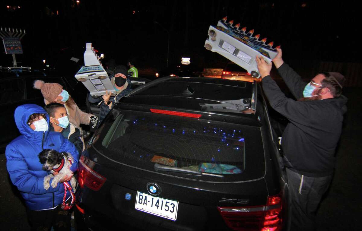 Members of Chabad of Fairfield hold a Car Menorah Parade along Post Road in Fairfield, Conn., on Thursday Dec. 10, 2020. A Menorah lighting to celebrate Hanukkah came at the end of the parade that started at Chabad of Fairfield, joined Chabad of Shelton and Chabad of Westport members midway along the route along Post Road in Fairfield.