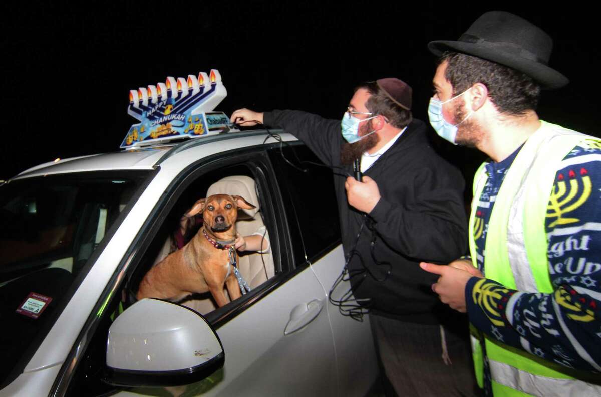 Members of Chabad of Fairfield hold a Car Menorah Parade along Post Road in Fairfield, Conn., on Thursday Dec. 10, 2020. A Menorah lighting to celebrate Hanukkah came at the end of the parade that started at Chabad of Fairfield, joined Chabad of Shelton and Chabad of Westport members midway along the route along Post Road in Fairfield.