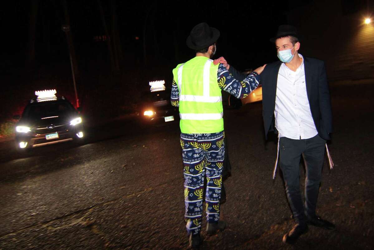 Members of Chabad of Fairfield hold a Car Menorah Parade along Post Road in Fairfield, Conn., on Thursday Dec. 10, 2020. A Menorah lighting to celebrate Hanukkah came at the end of the parade that started at Chabad of Fairfield, joined Chabad of Shelton and Chabad of Westport members midway along the route along Post Road in Fairfield.