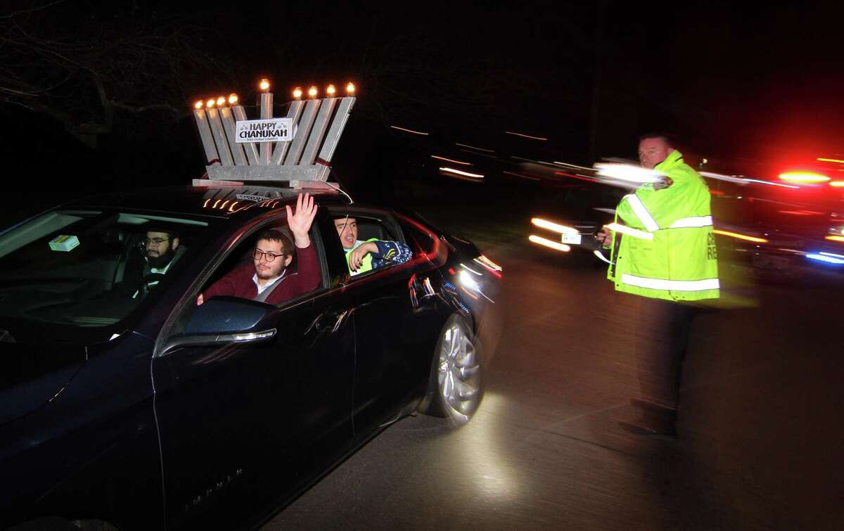Members of Chabad of Fairfield hold a Car Menorah Parade along Post Road in Fairfield, Conn., on Thursday Dec. 10, 2020. A Menorah lighting to celebrate Hanukkah came at the end of the parade that started at Chabad of Fairfield, joined Chabad of Shelton and Chabad of Westport members midway along the route along Post Road in Fairfield.