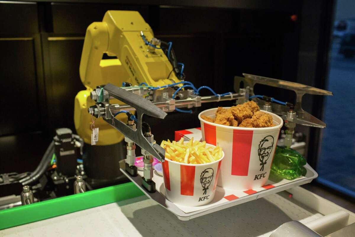 A robotic arm lifts an order of food from a conveyor belt inside a new contactless Kentucky Fried Chicken restaurant in Moscow, Russia, on June 12.
