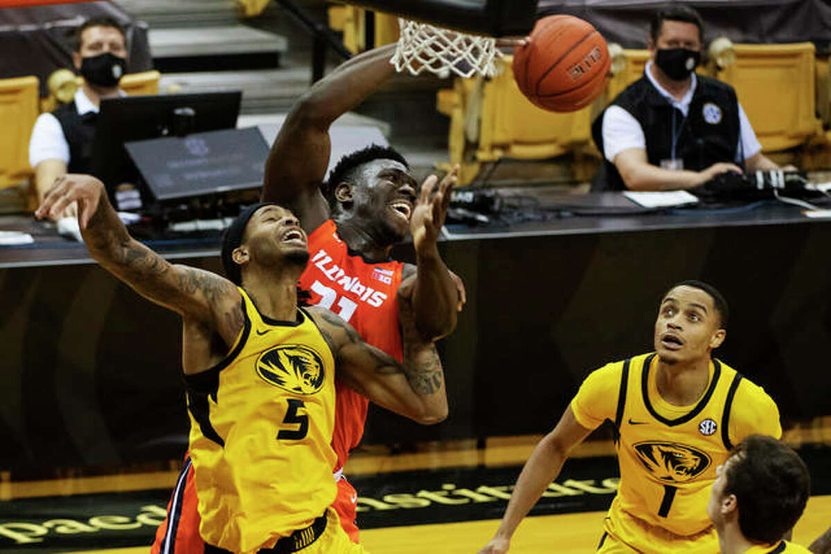 Missouri’s Mitchell Smith, left, and Illinois’ Kofi Cockburn, center, collide while Xavier Pinson, right, during the first half of an NCAA college basketball game Saturday, Dec. 12, 2020, in Columbia, Mo.