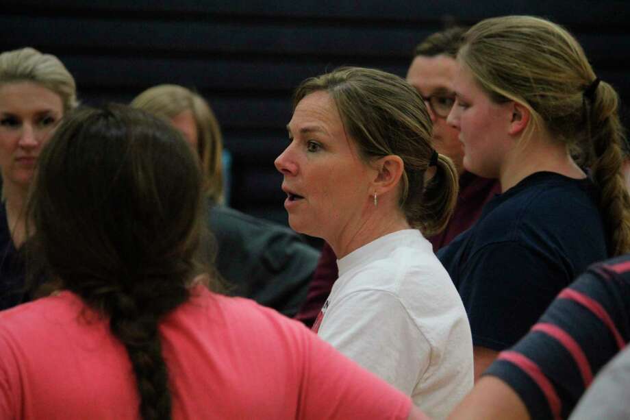 Big Rapids athletic director Dawn Thompson (center), also softball coach, talks with her team last March after what would be its final practice before the season suspension because of COVID. (Pioneer file photo)