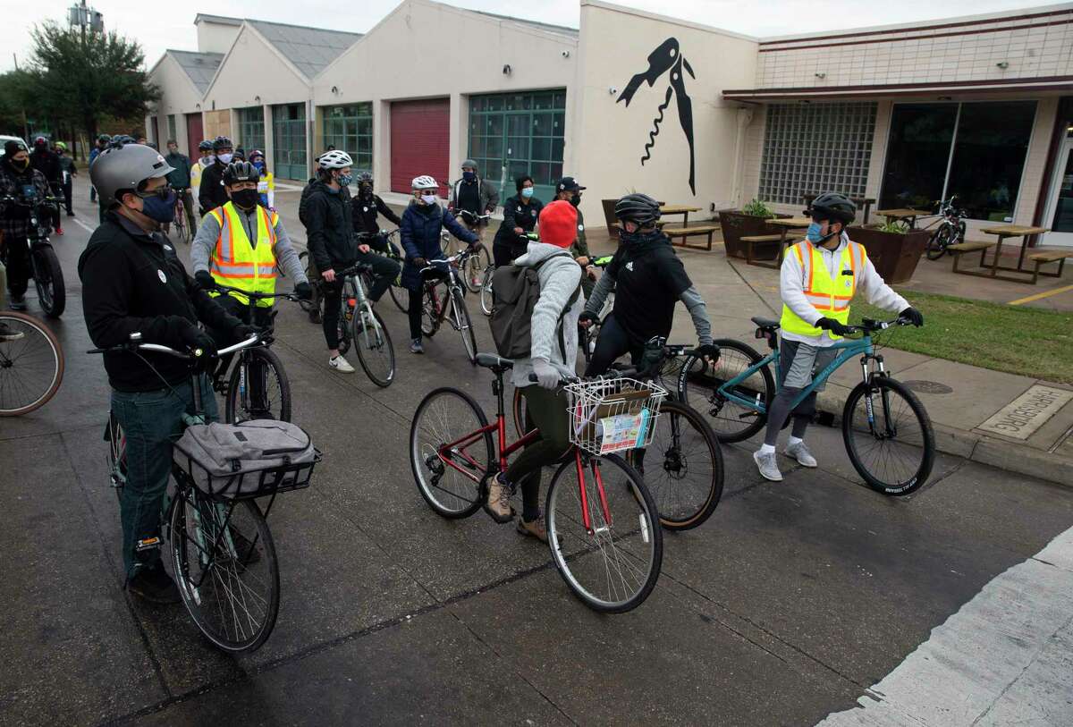 Houston City and Harris County officials and bike community members wait for a traffic light at Sampson Street and Harrisburg Boulevard and learn about the business development in the neighborhood during a bike ride tour Saturday, Dec. 5, 2020, at East End in Houston. The East End Bike Plan, which covers the 16 square miles of the East End District boundaries, will identify bike route improvements in the area based on the community’s feedback. Development of this Plan is expected to be completed in 2021.