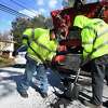 A Trumbull Public Works crew utilizes the town's new hot box to fill potholes with heated patching material on Lake Avenue in Trumbull, Conn. on Wednesday, January 30, 2019.