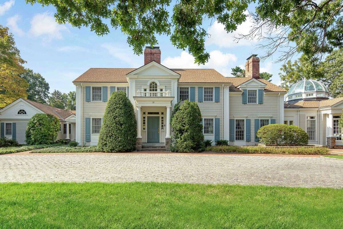 Main house of an 11.16-acre country estate at 1211 Old Academy Road, Fairfield. A scrim of mature trees hides from view this family compound that includes a long list of living, entertaining and recreational amenities. It's clear from the moment one turns into the driveway that boredom will never find the residents of this special place. The property features an outdoor tennis court and a three-stall tennis barn; a field house with a gymnasium and an indoor court for racquetball, squash and volleyball; and a heated Gunite in-ground swimming pool and pool house surrounded by a patterned brick terrace.