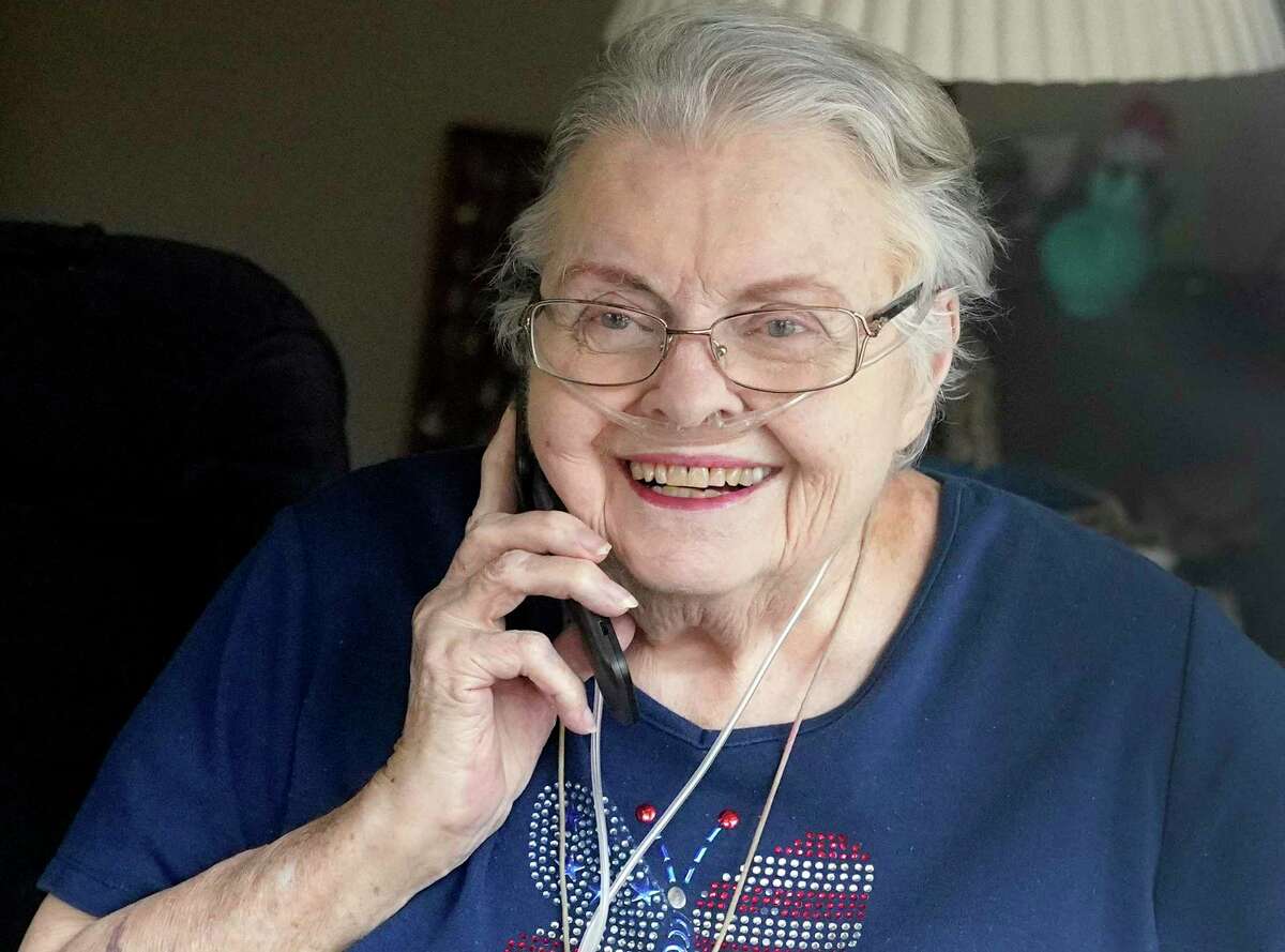 Ann Criswell, a resident at The Waterford at College Station, 1103 Rock Prairie Rd., is shown through her room window as she speaks to her daughter, Cathy Lester, who stood outside for their visit Sunday, April 19, 2020, in College Station. A majority of the residents have tested positive for COVID-19.