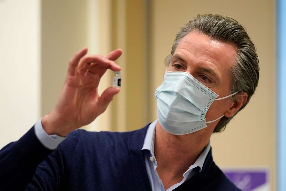 Gov. Gavin Newsom holds up a vial of the Pfizer COVID-19 vaccine at Kaiser Permanente Los Angeles Medical Center on Dec. 14, 2020. On Tuesday, Newsom said the state would pause vaccinations of the Johnson & Johnson vaccine after reports of blood clots in six women in the U.S. who had received it.