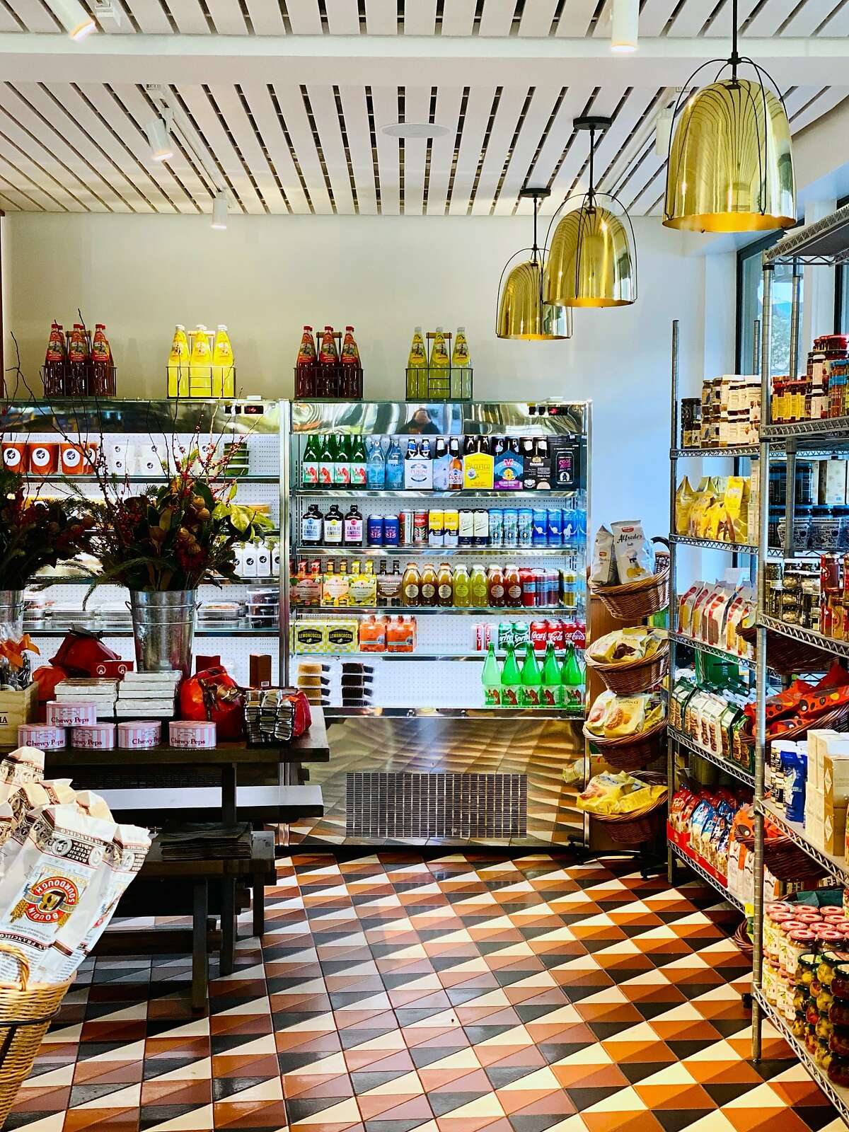 The interior of Little Original Joe's, which includes a market space where customers can shop for dry goods like flour, or pick up frozen dinners.