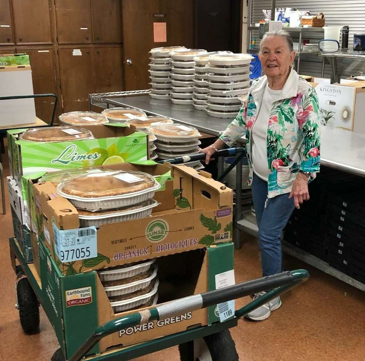 A Keep Us Fed volunteer with donated baked goods from Costco following Thanksgiving. They were distributed to five partner organizations across the county.