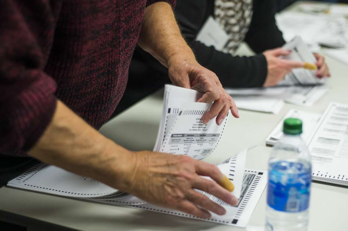 Ballots are counted during an official recount for the race between Midland City Council Ward 1 candidates, incumbent Pam Hall and Jeremy Rodgers, Tuesday, Dec. 15, 2020 at the Homer Township Fire Department. Hall retained her victory in the election, though the margin narrowed from 11 votes to nine votes.(Katy Kildee/kkildee@mdn.net)