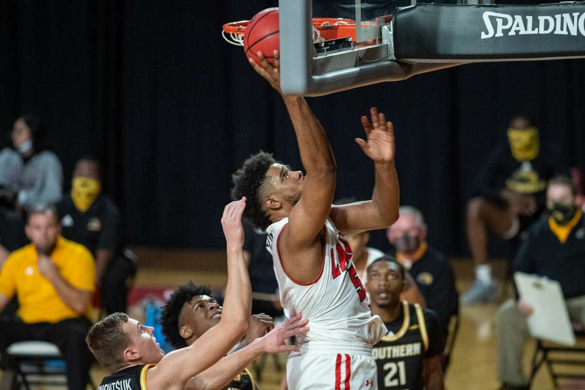 Cardinals Avery Sullivan (5) tucks a shot in the basket in the first half. The Lamar Cardinals men's basketball team hosted the Southern Mississippi Golden Eagles at the Montagne Center Tuesday night. Photo made on December 15, 2020. Fran Ruchalski/The Enterprise
