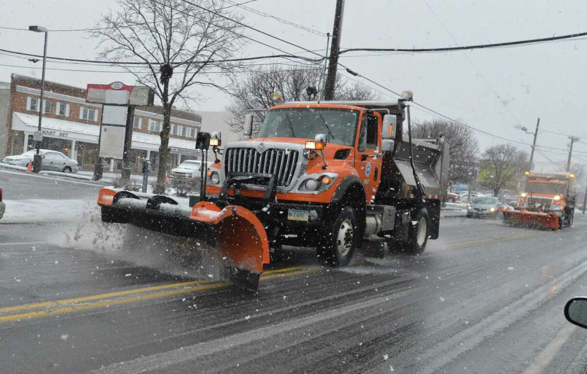 State of Connecticut plow trucks make a pass along Main Ave. in Norwalk Conn. as snow falls on Wednesday March 8, 2018 in Norwalk Conn.