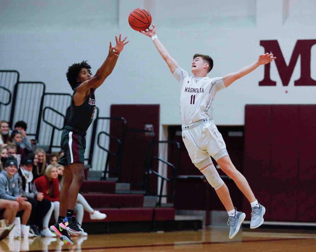 Magnolia senior Connor Lindvall (11) gets a hand on a shot as the Bulldogs opened up District 19-5A play against Waller at home on Tuesday, Dec. 15, 2020.