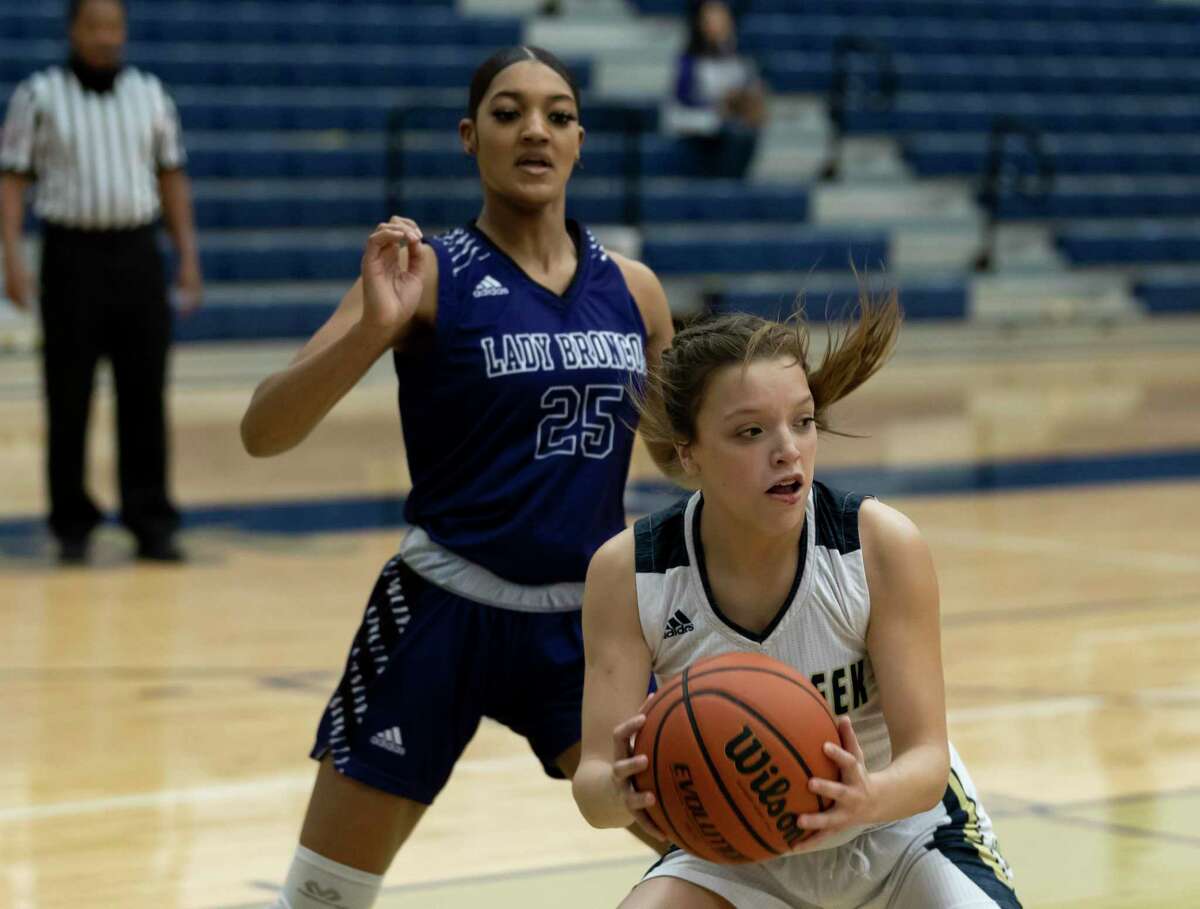 Lake Creek shooting guard Kennedy Oliver (5) looks for an opening to pass the ball while under pressure from Dayton power forward Loryn Mallet (25) during the first quarter of a non-district girls basketball game at Lake Creek High School, Tuesday, Dec. 15, 2020, in Montgomery.