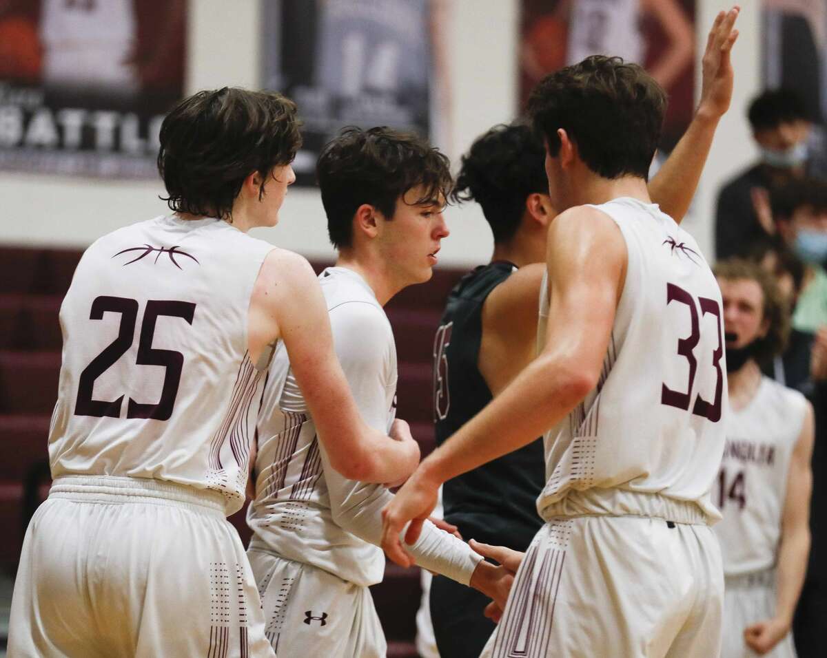 Magnolia guard Mason Machado (20) is is mobbed by teammates after guard Mason Machado drew a foul on Waller guard Isaiah Naples shooting a 3-pointer during the fourth quarter of a high school basketball game at Magnolia High School, Tuesday, Dec. 15, 2020, in Magnolia.