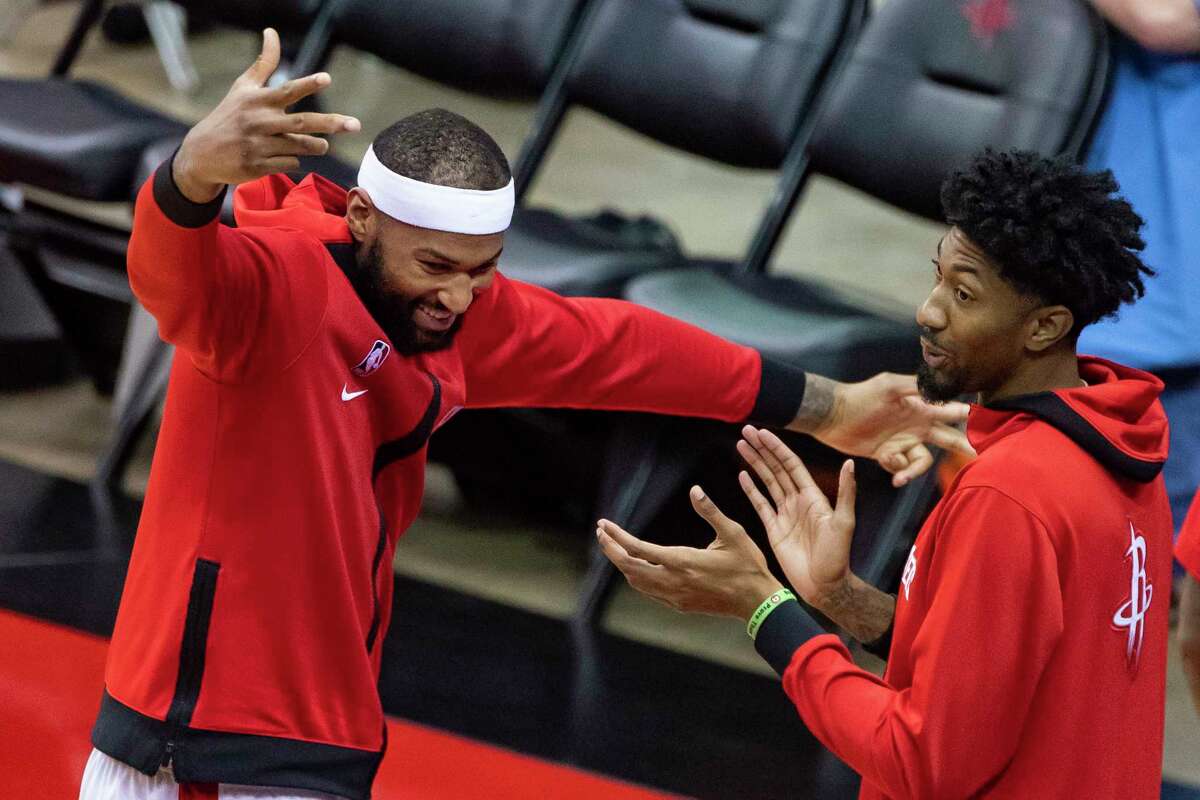 Houston Rockets center DeMarcus Cousins (15) and forward Christian Wood (35) react from the sideline after a shot by Houston Rockets forward Bruno Caboclo (5) during the second half of a preseason game between the Houston Rockets and San Antonio Spurs on Tuesday, Dec. 15, 2020, at Toyota Center in Houston.