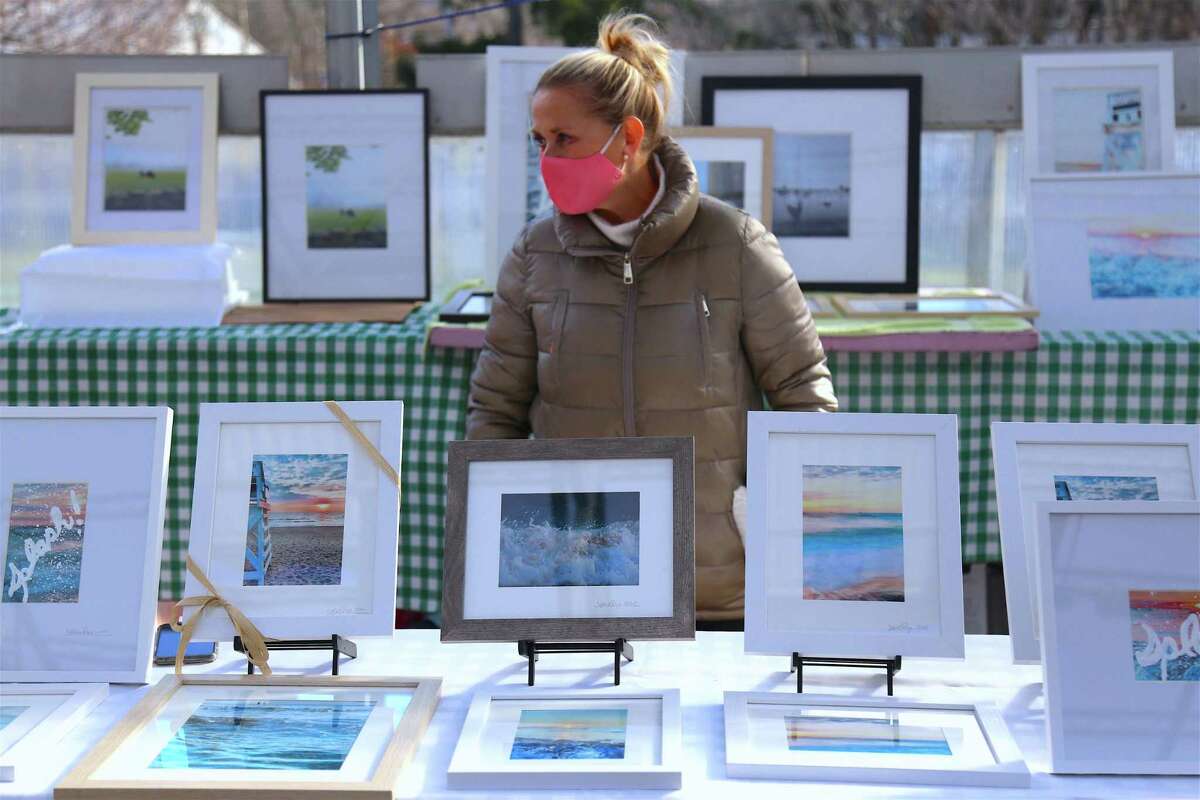 Photographer Jessica Ryan, of Southport, stands by her work at the Westport Farmer's Market on Tuesday, Dec. 15, 2020.