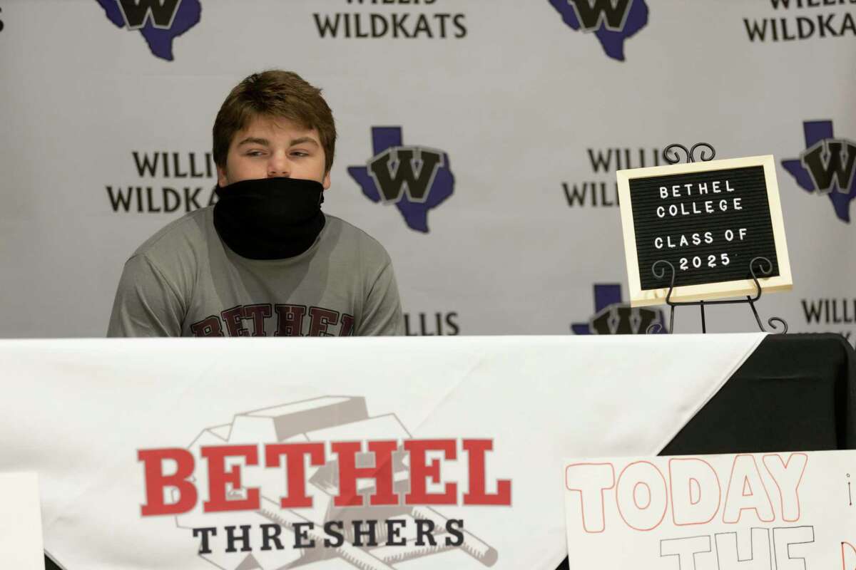 Jace Halbaedier, who signed with Bethel College's football team, looks at his family during a National Signing Day ceremony at Willis High School, Wednesday, Dec. 16, 2020, in Willis.