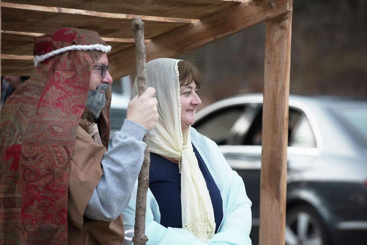 Mary and Joseph greet visitors to the drive-by living nativity presented Sunday by Wilton Presbyterian and St. Matthew's Episcopal churches. With neither church offering in-person services for Christmas, the pastors arranged the living nativity as a way for congregants to experience the holiday spirit through "I Believe: The Road to Bethlehem." "Even in the midst of this pandemic, the miracle of Christmas cannot be stopped," said the Rev. Shannon White, pastor of Wilton Presbyterian Church.