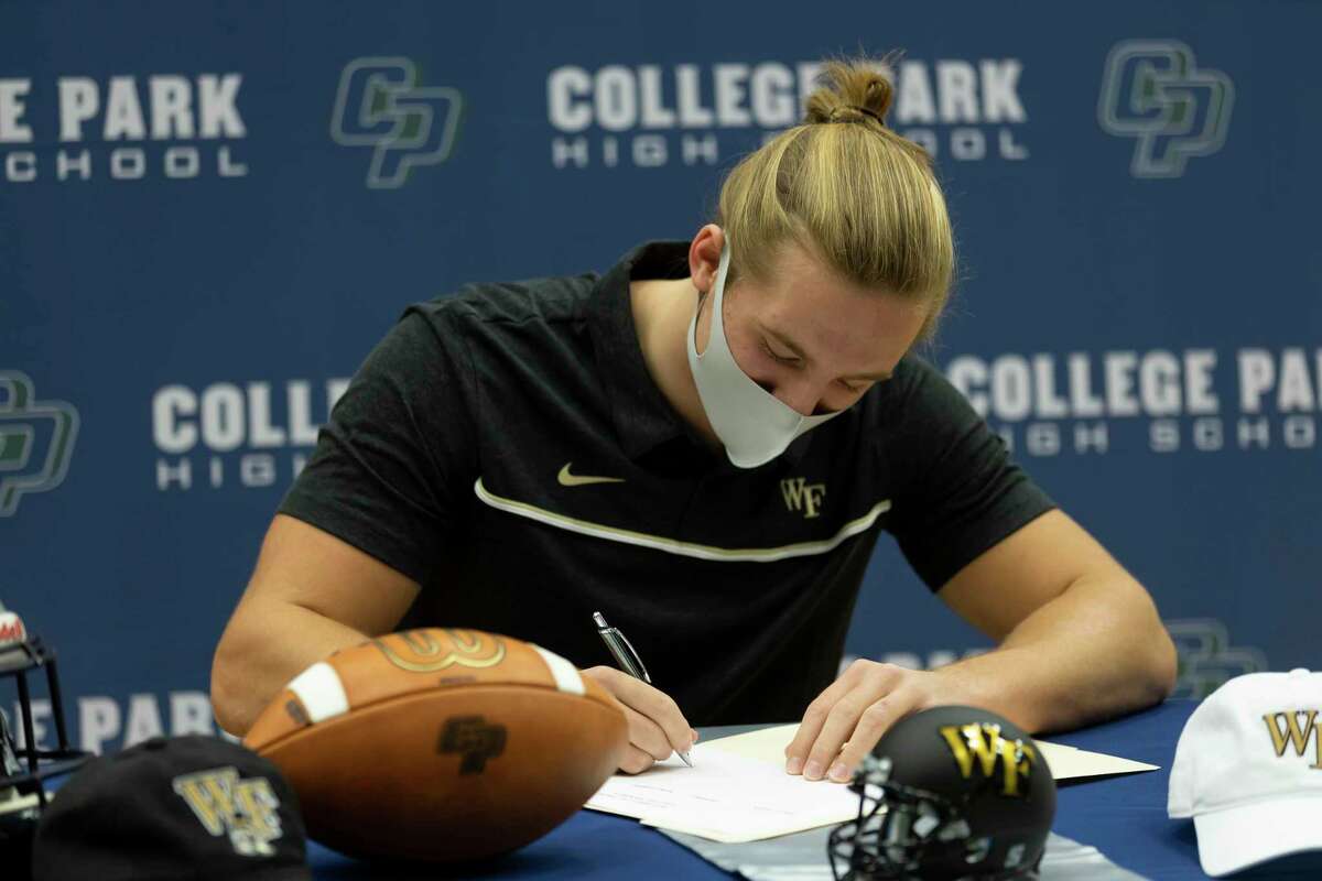 Dylan Hazen, who signed with Wake Forest's football team, signs during a National Signing Day ceremony at College Park High School, Wednesday, Dec. 16, 2020, in The Woodlands.