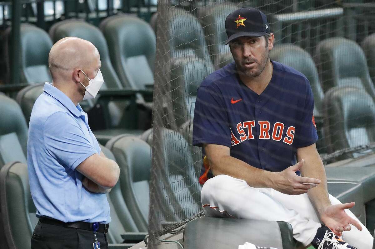 Justin Verlander, shown here talking with Astros general manager James Click in 2020, will be back with the Astros in 2022 and possibly 2023.